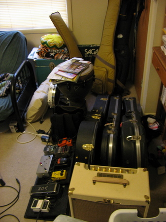 7 guitars, including a Les Paul, Ephiphone Dot, Takamine acoustic, Warwick fretless bass, 5 string no-name bass, Gretsch Duo-Jet, and PRS clone kit guitar.